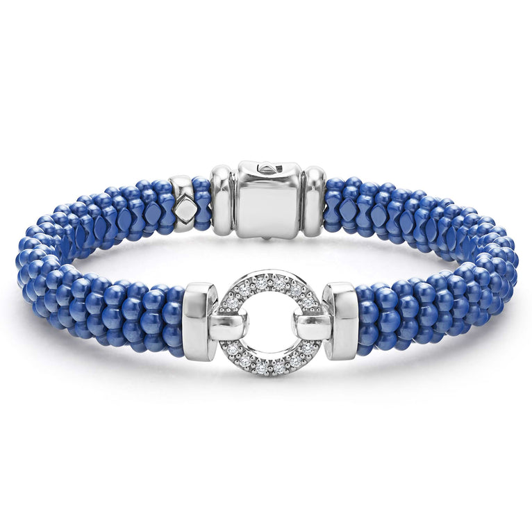 A sterling silver bracelet in the middle of a white background features a diamond circle motif and ultramarine ceramic caviar beading.