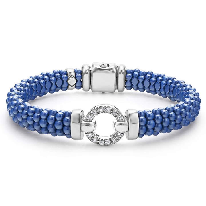 A sterling silver bracelet in the middle of a white background features a diamond circle motif and ultramarine ceramic caviar beading.