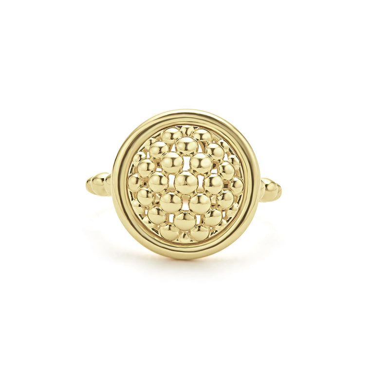 An 18K Gold ring in the middle of a white background featuring caviar beading and smooth gold detailing.