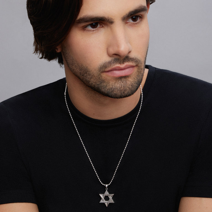 A man wearing a Star of David Amulet with a chain necklace