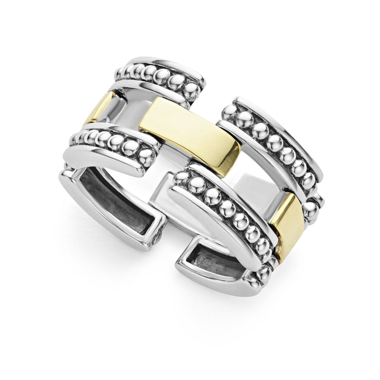 A sterling silver and 18k gold ring displayed angled in the middle of a white background featuring smooth stations of 18K gold set by sterling silver Caviar beading