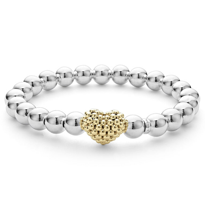 A sterling silver and 18k gold beaded bracelet in the middle of a white background featuring an 18k gold and silver Caviar beaded heart accent