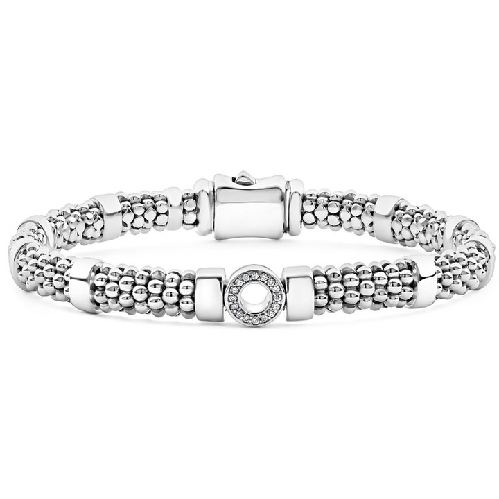 A sterling silver bracelet in the middle of a white background featuring one diamond circle station and caviar beading.