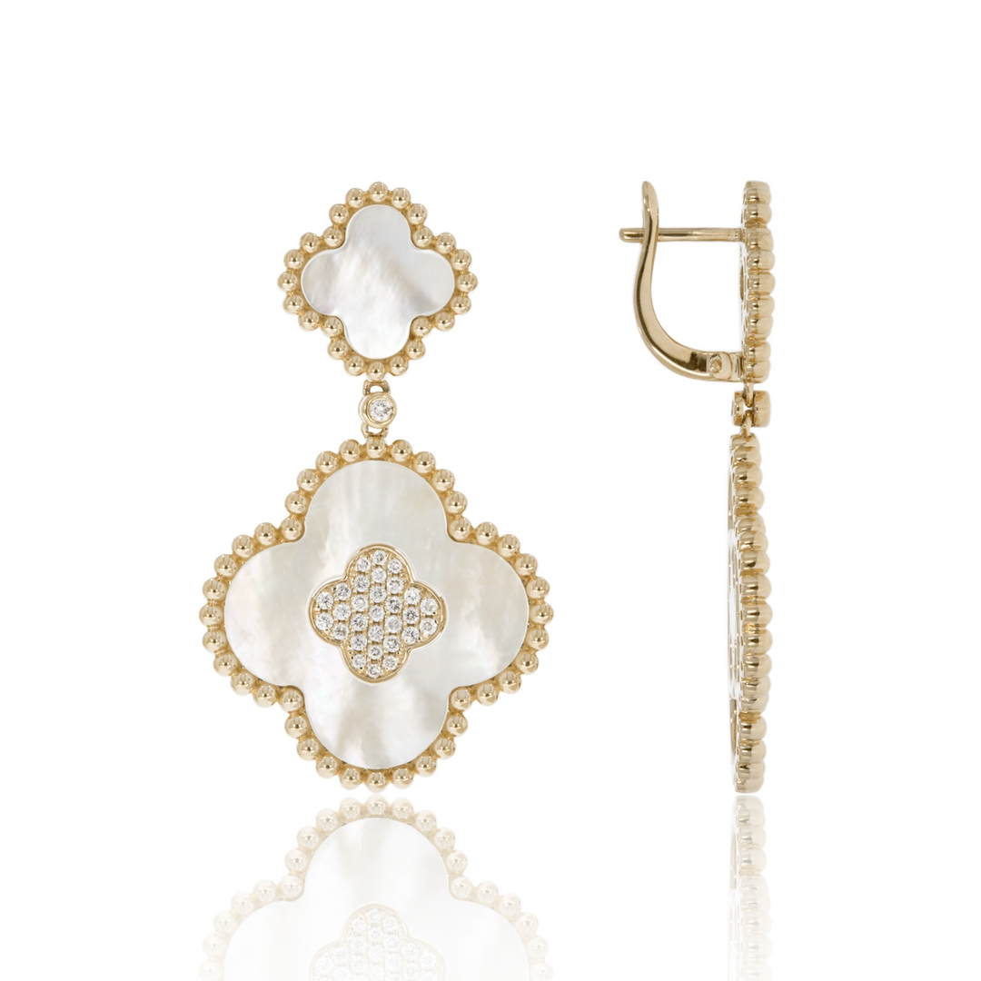 A pair of drop earrings with two clover motifs with white mother-of-pearl stones and gold caviar beading. The right earring is angled to the side.