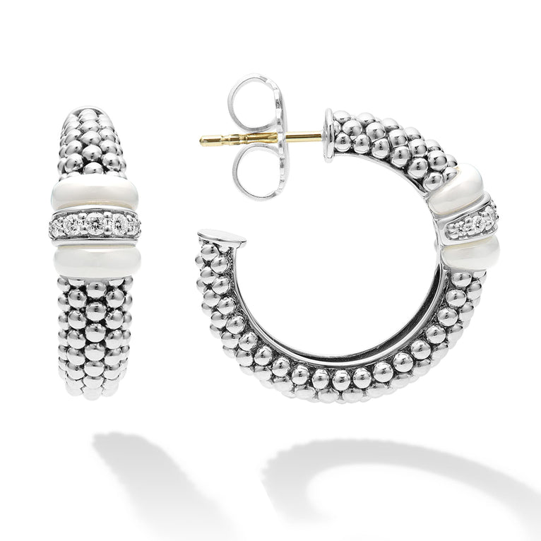 A pair of hoop earrings with white ceramic and a diamond station with sterling silver Caviar beads. The right earring is angled to the side, showing the back.