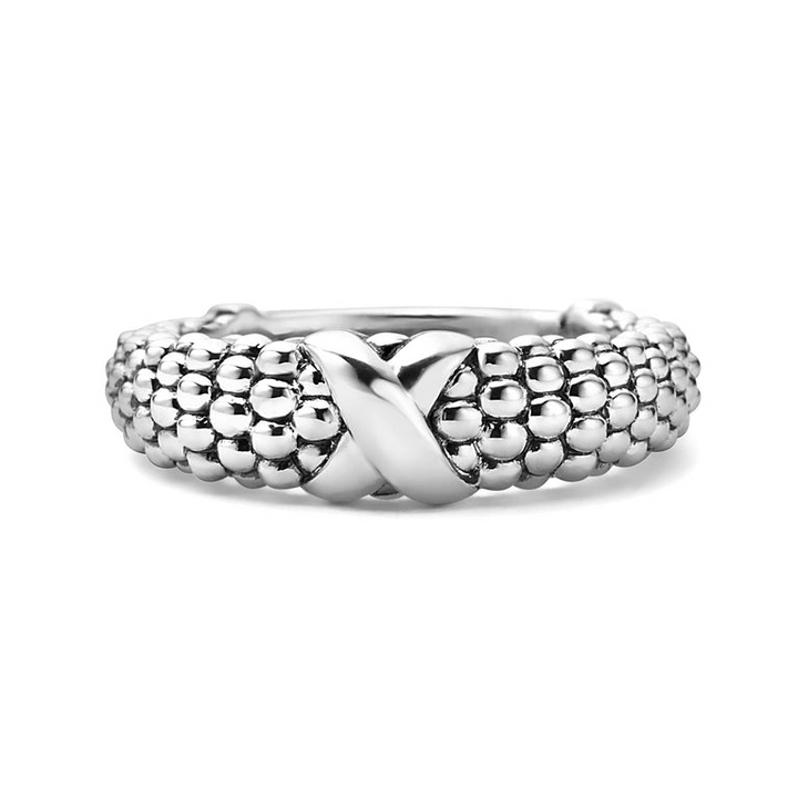 A sterling silver ring displayed in the middle of a white background featuring an x motif and silver Caviar beading