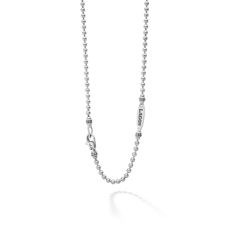 A sterling silver chain highlighting the clasp featuring a ball chain.