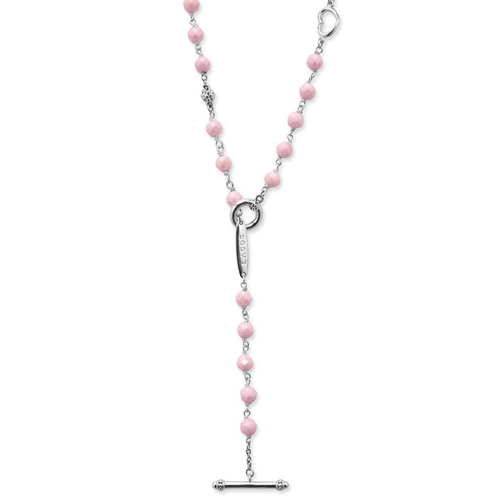 A sterling silver and ceramic beaded necklace in the middle of a white background featuring pink ceramic and silver caviar beading highlights the toggle clasp.