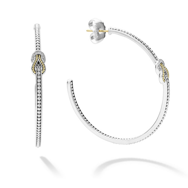 A pair of hoop earrings with diamonds and 18K gold woven in a knot motif. The right earring is angled to the side, showing the back.