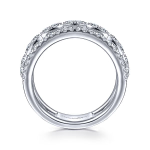 A close-up of a 14k white-gold stackable ring resting vertically in the middle of a white background. The ring features two outer brands with pave diamonds and a center row of marquise-shaped diamonds.