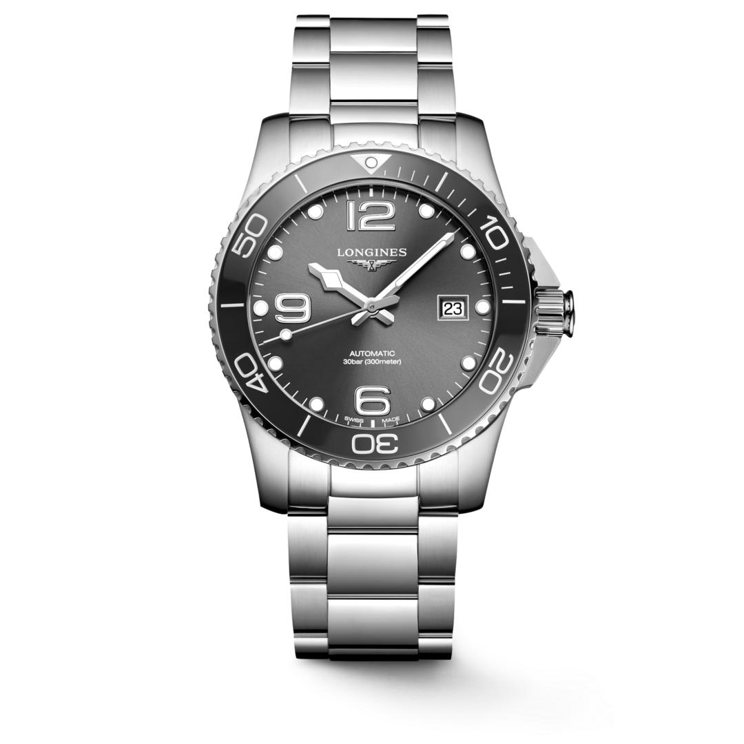 A Longines watch standing straight against a transparent background. The watch features a black dial, white hands and markers, a black bezel, a crown on the right, and a stainless steel bracelet.