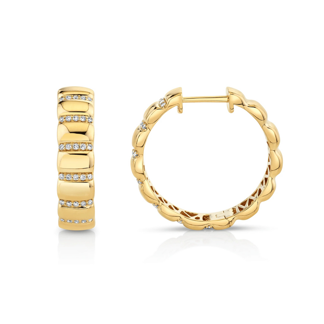 Two yellow-gold earrings against a white background. The rounded hoop earrings feature a floating diamond in the center.