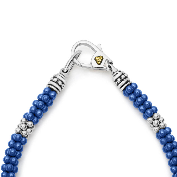 A close-up of a Sterling Silver & 18K Gold bracelet in the middle of a white background focusing on the clasp, featuring seven sterling silver stations and ultramarine caviar beading