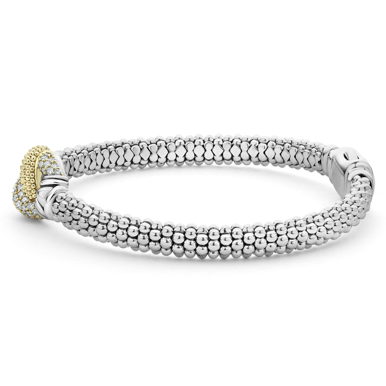 A side-view of a Sterling Silver and 18k gold bracelet is displayed on a white background. The bracelet features diamonds and gold women in a knot motif.