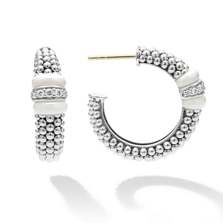 A pair of hoop earrings with white ceramic and a diamond station with sterling silver Caviar beads. The right earring is angled to the side.