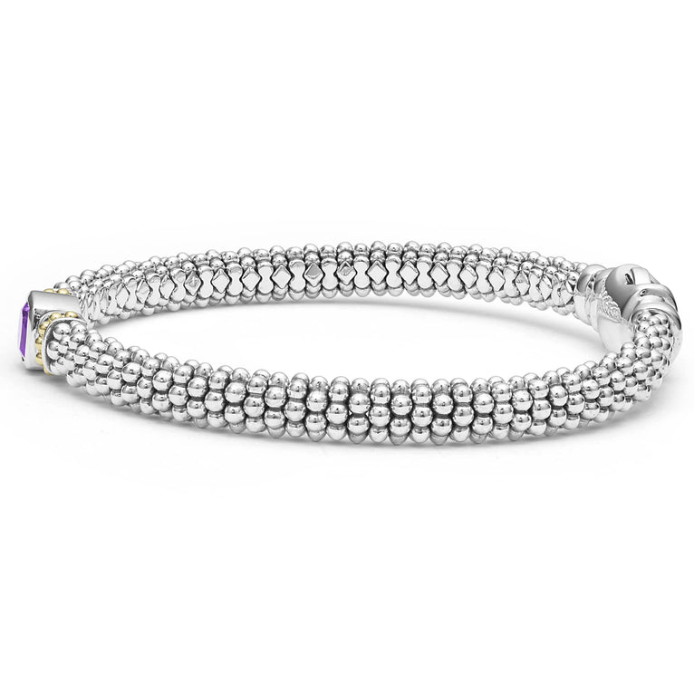 A side-view of a sterling silver bracelet in the middle of a white background features an amethyst gemstone and sterling silver Caviar beading with 18K gold detailing.