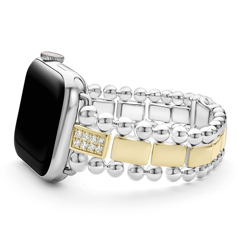 An Apple watch resting on its left side against a white background. The watch band features 18K gold-stationed links and stainless steel beading around the links.