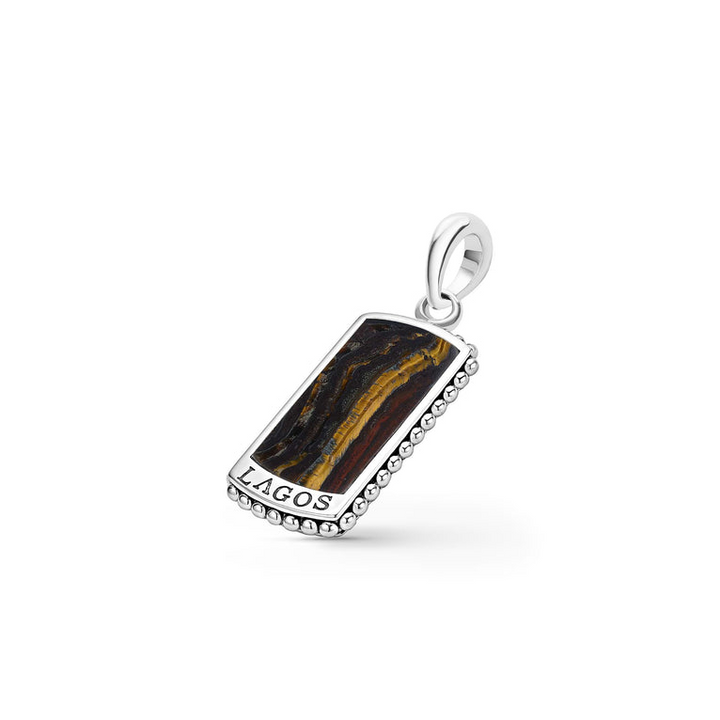 A Tiger Iron Tag Amulet featuring a Tiger Iron gemstone accented by sterling silver Caviar beading is  displayed to the right in the middle of a white background