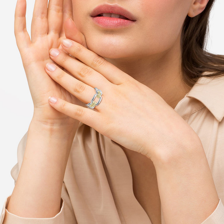 A woman is wearing a sterling silver and 18k gold ring featuring Sterling silver and18k gold variations of Caviar beading and fluting elements