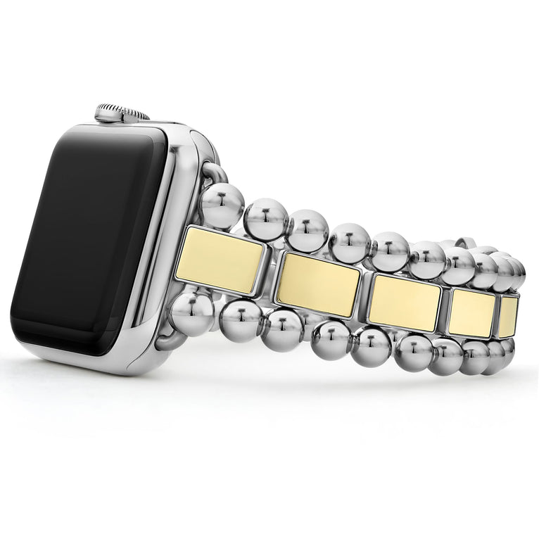 An Apple watch resting on its left side against a white background. The watch band features 18K gold-stationed links and stainless steel beading around the links.