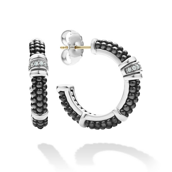 A pair of hoop earrings with Black ceramic Caviar beading, sterling silver, and diamonds. The right earring is angled to the side, showing the back.