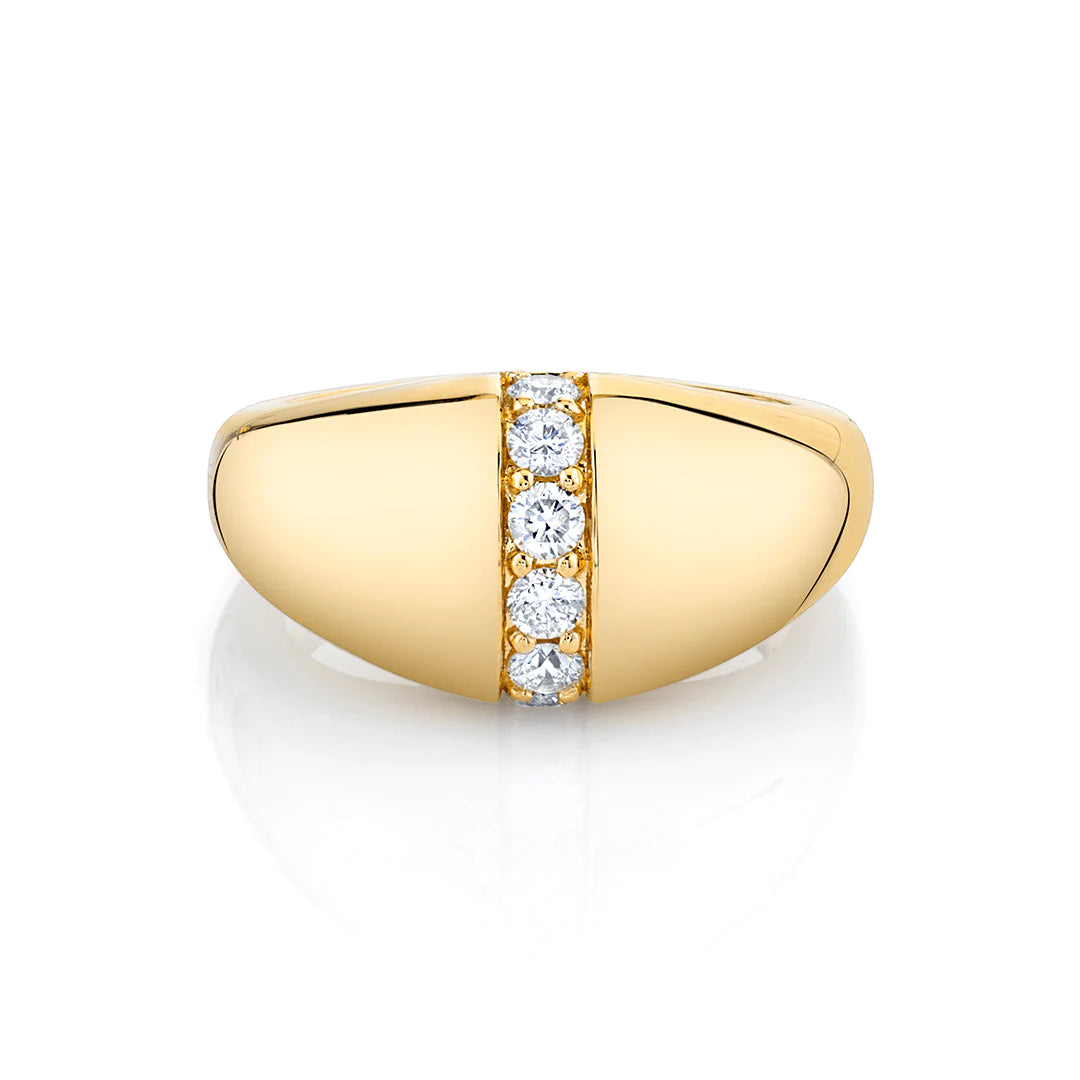 A yellow-gold ring lies flat against a white background. It features a unique band with a row of diamonds in the middle.