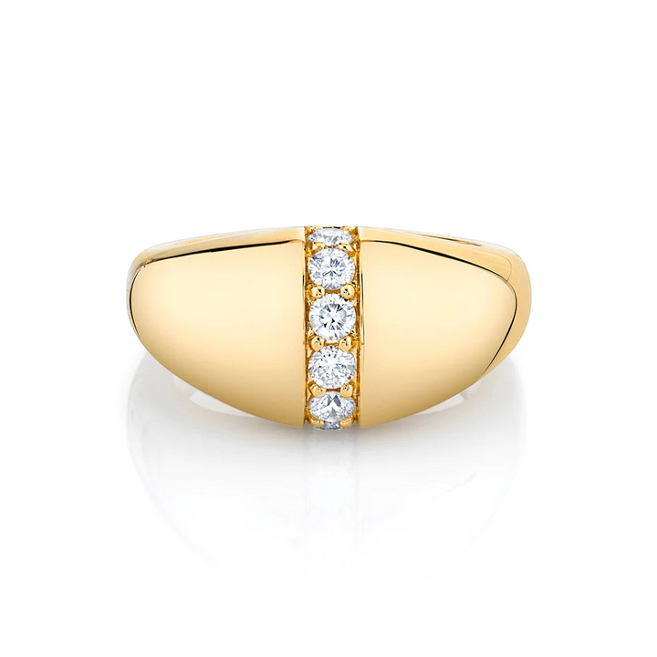 A yellow-gold ring lies flat against a white background. It features a unique band with a row of diamonds in the middle.