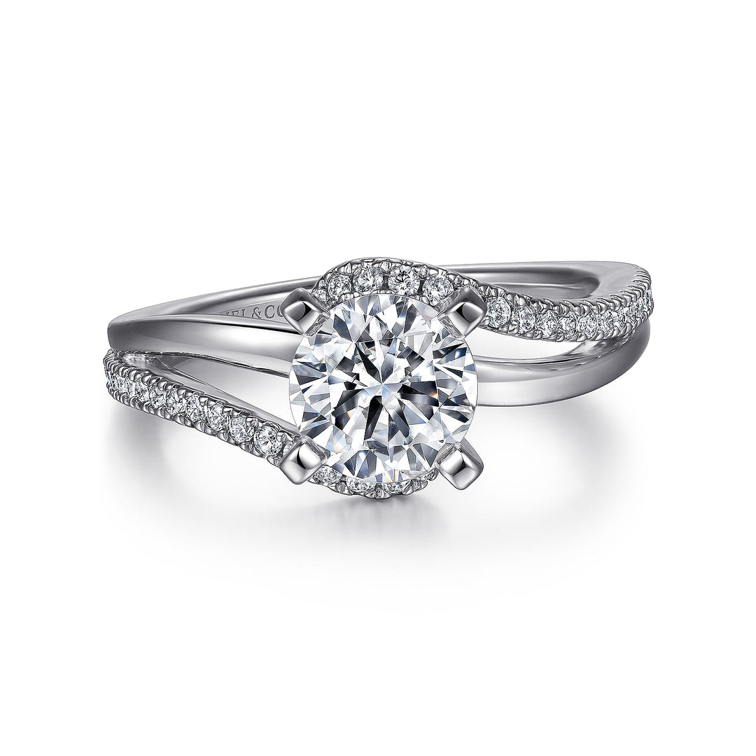 A white gold ring lies flat against a white background. It features an oval-cut diamond set in the center.