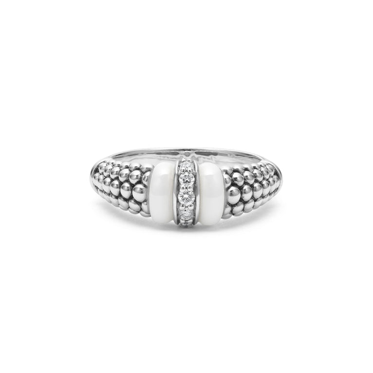 A sterling silver ring is displayed on a white background featuring white ceramic caviar beading with a row of diamonds.