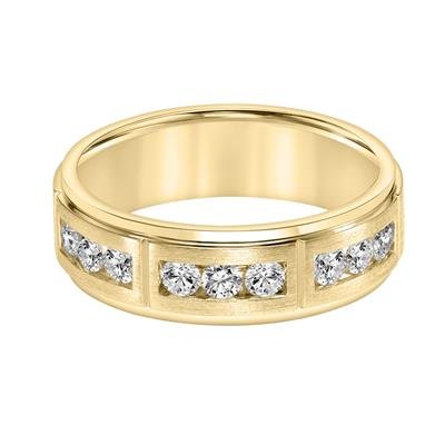 A yellow-gold ring is displayed in the middle of a white background. The ring features diamond stations with three diamonds.