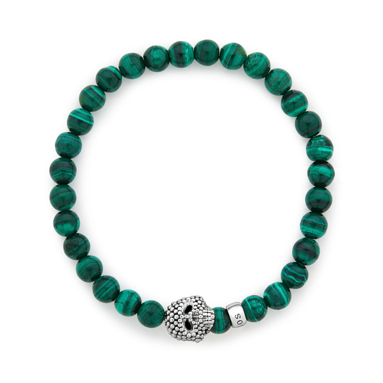 A sterling silver bracelet is displayed in the middle of a white background featuring a Malachite gemstone beaded bracelet with a sterling silver Caviar skull.