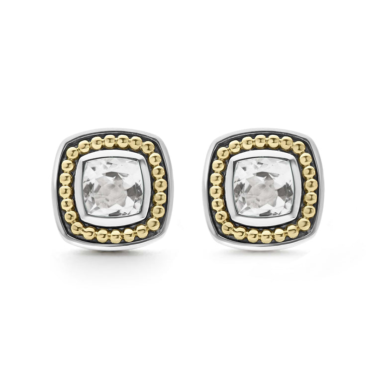 A pair of stud earrings with a White topaz gemstone surrounded by sterling silver and 18k gold Caviar beading. 