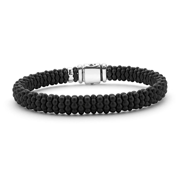 A sterling silver beaded bracelet in the middle of a white background featuring Matte black ceramic caviar beading