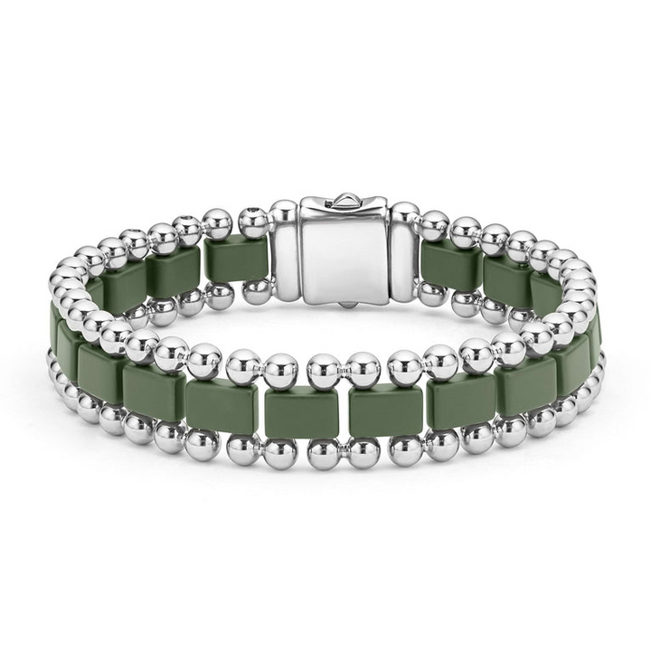 A stainless steel bracelet in the middle of a white background featuring matte hunter-green ceramic and caviar beading.