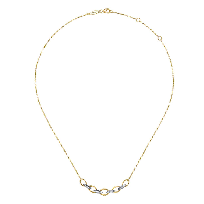 A yellow-gold Twisted Rope Oval Link Necklace with Diamond Connectors in the middle of a white background. The necklace features a chain link design with loops of twisted yellow gold joined by brilliant kite-shaped diamond links