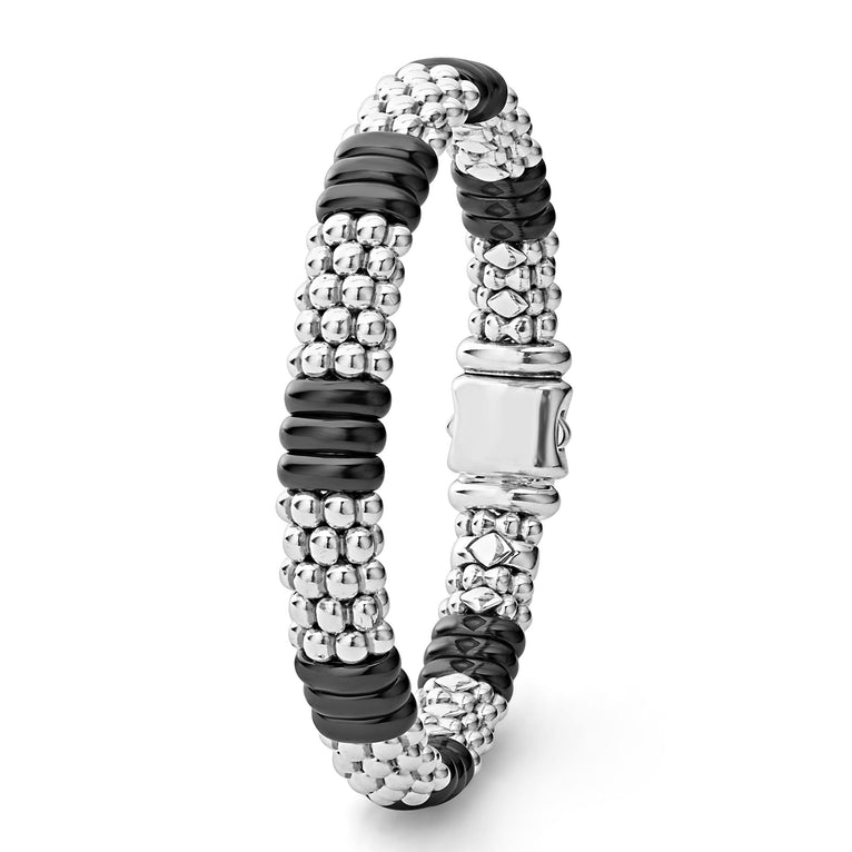 A sterling silver beaded bracelet standing vertically in the middle of a white background, featuring Sterling silver Caviar beading and smooth black ceramic