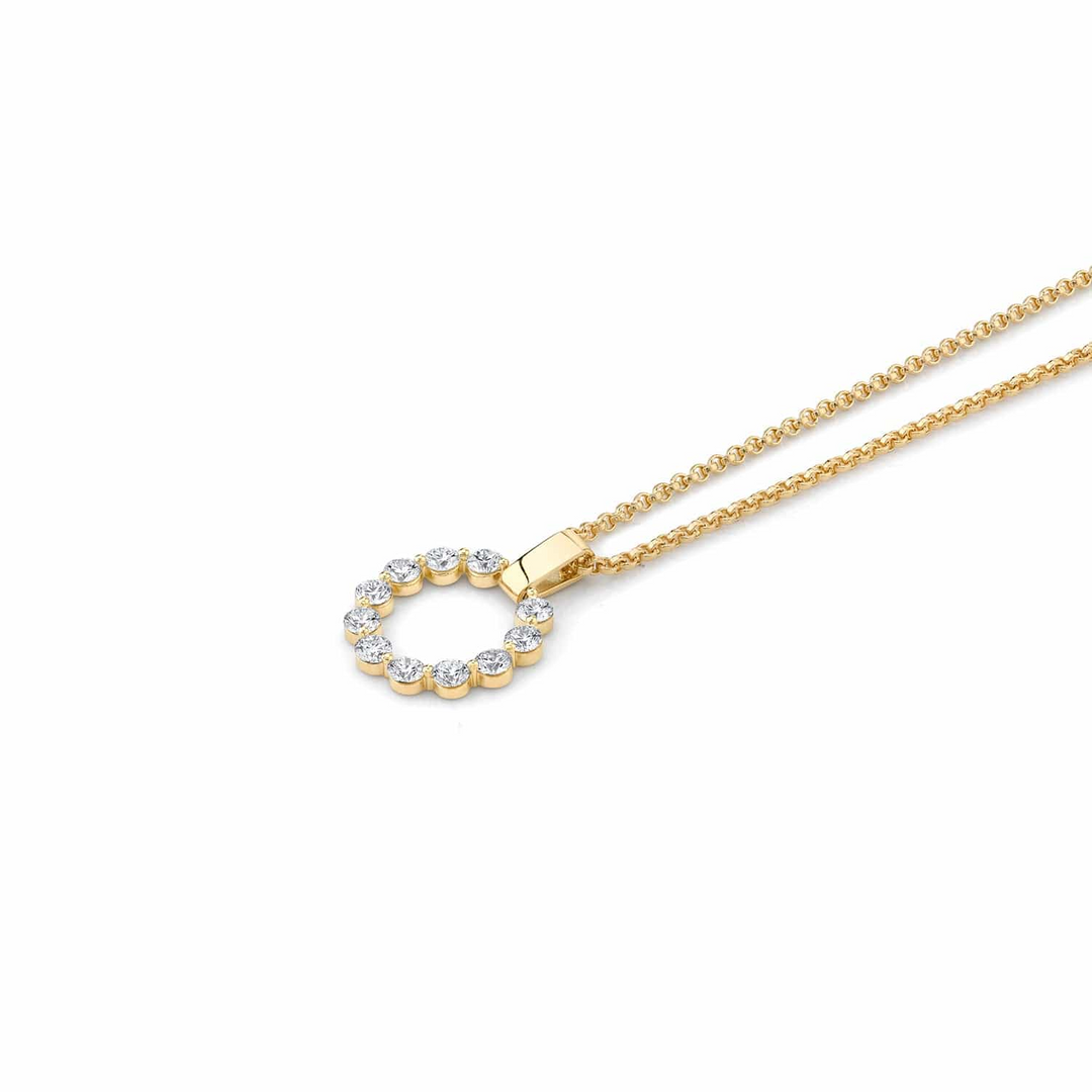 A yellow-gold necklace lying flat across a white background. The bracelet features a circle pendant and a smooth gold bar with a belcher chain.