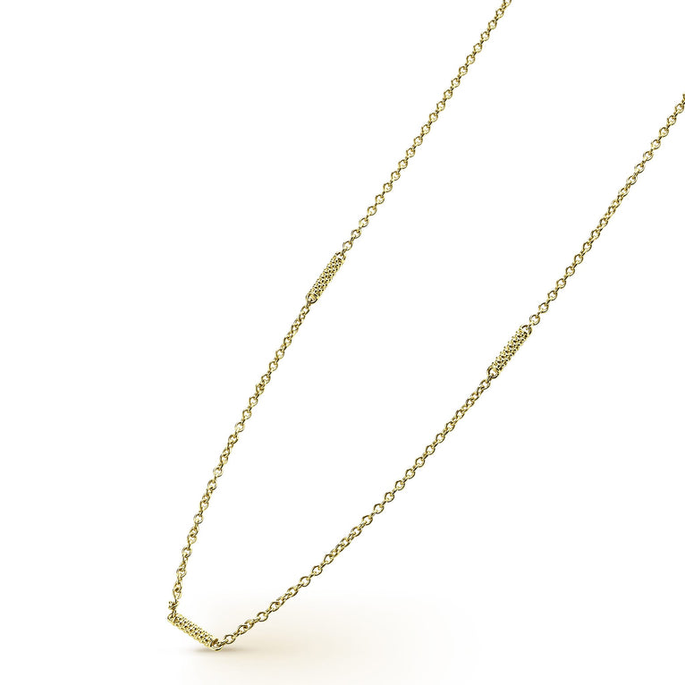 An 18k gold chain necklace angled to the right featuring caviar-beaded stations on a white background.