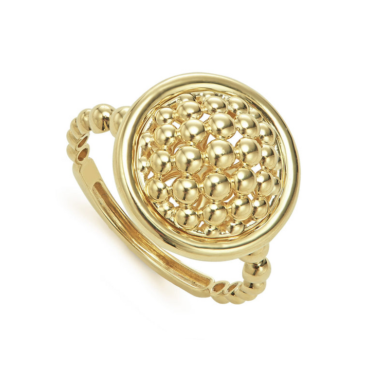 An 18K Gold ring in the middle of a white background featuring caviar beading and smooth gold detailing.