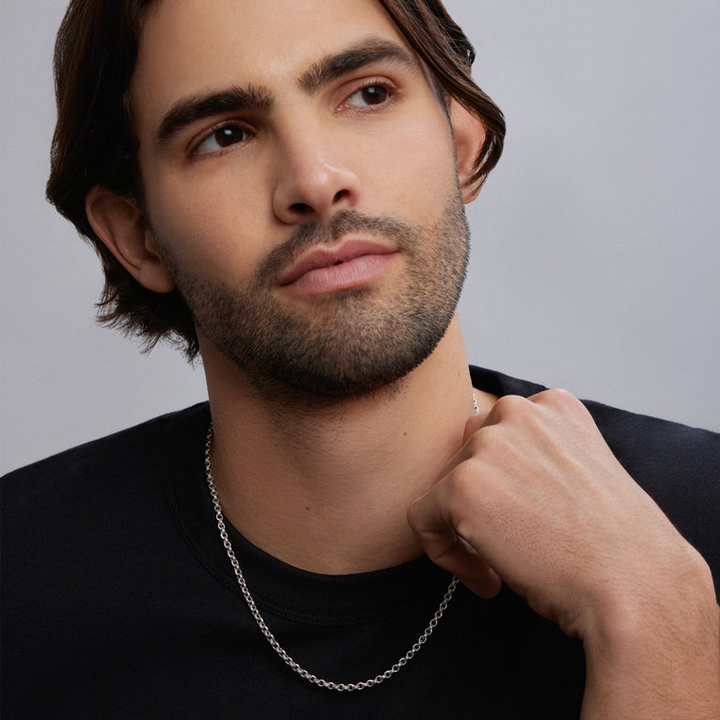 A man wearing a sterling silver chain featuring Sterling silver fluted links and double link Caviar chain