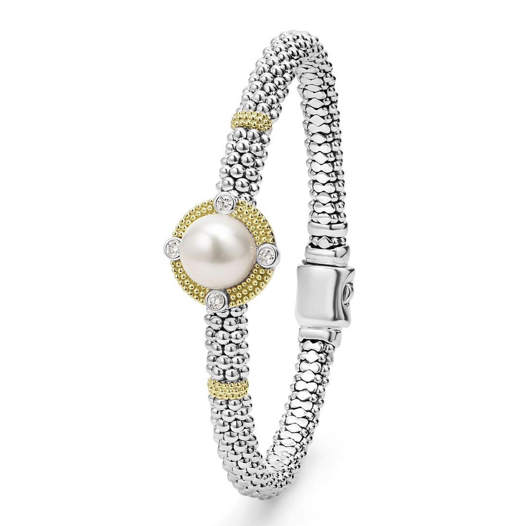 A sterling silver & 18k gold bracelet standing vertically in the middle of a white background featuring a freshwater cultured pearl surrounded by diamonds, smooth sterling silver, Caviar beading, and 18K gold stations.