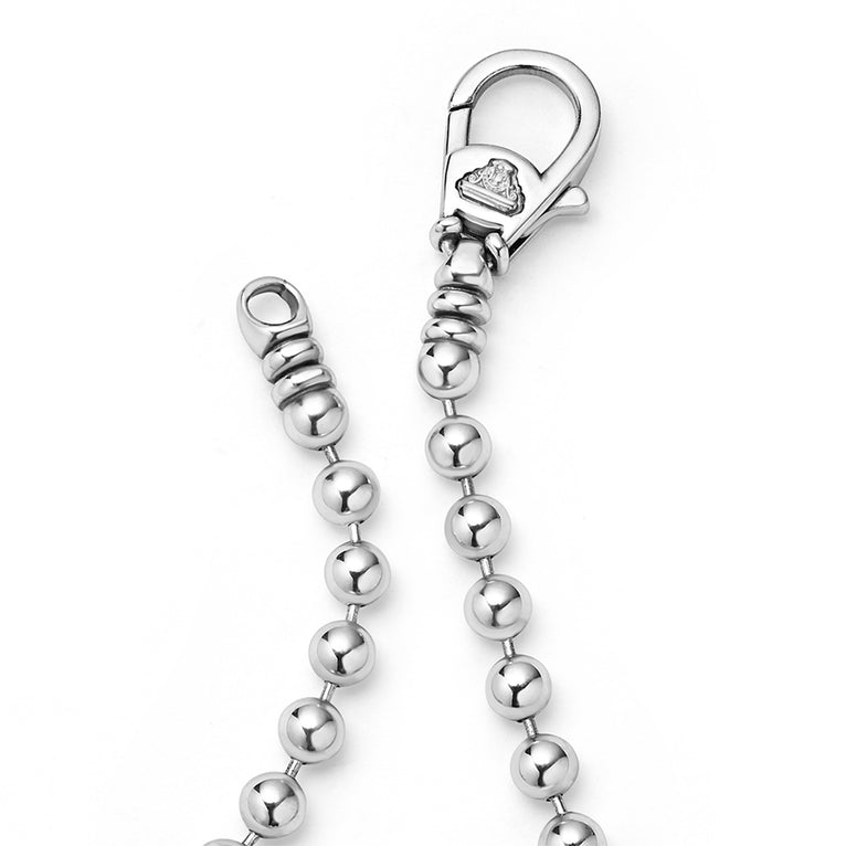 A sterling silver bracelet unclasped with Smooth sterling silver accented by Caviar beaded stations on a ball chain.