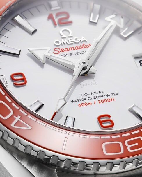 This is a close-up of an Omega watch angled to the right against a transparent background focusing on the dial. Dial has a white dial, orange bezel, and silver hands and markers.