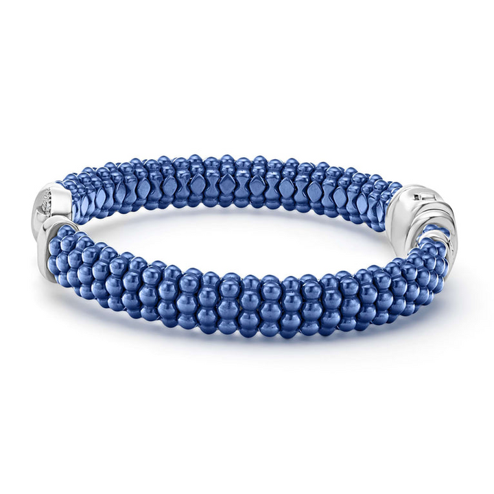 A side-view of a sterling silver bracelet in the middle of a white background features a diamond circle motif and ultramarine ceramic caviar beading.