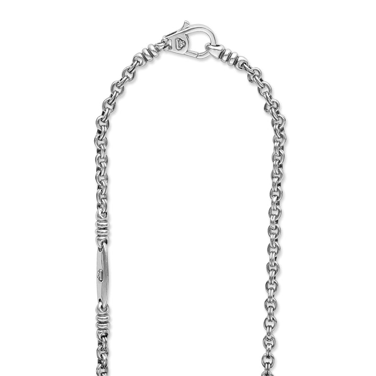 A sterling silver chain highlighting the clasp featuring Sterling silver fluted links and double link Caviar chain