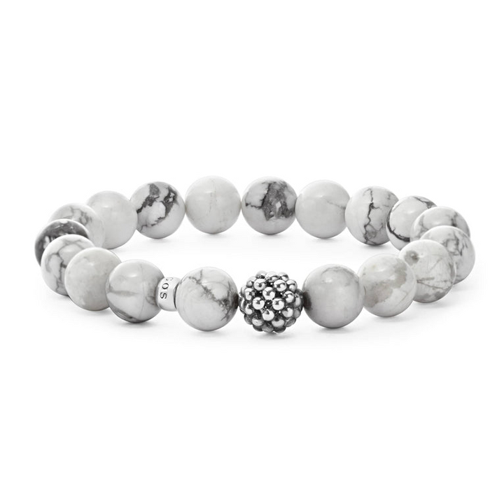 A bracelet is in the middle of a white background, featuring Howlite gemstone and silver Caviar bead station.