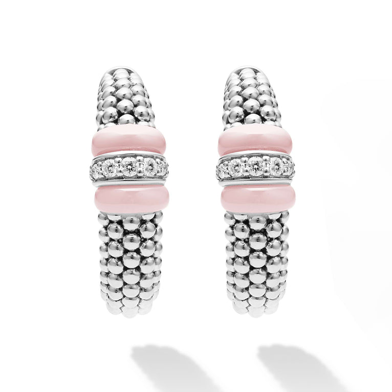 A pair of hoop earrings with pink ceramic and a diamond station with sterling silver Caviar beads. The right earring is angled to the side, showing the back.