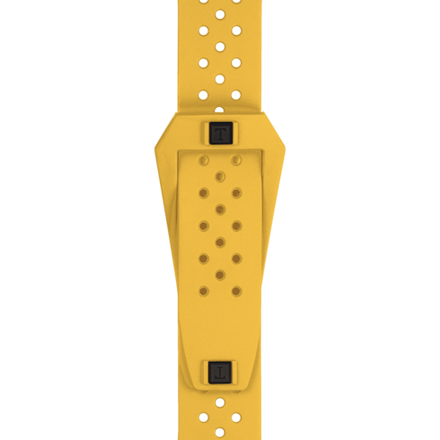 A close-up of the watch's yellow rubber strap with the Tissot logo buckle in the middle against a transparent background