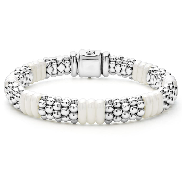 A sterling silver beaded bracelet in the middle of a white background featuring Sterling silver Caviar beading and smooth white ceramic