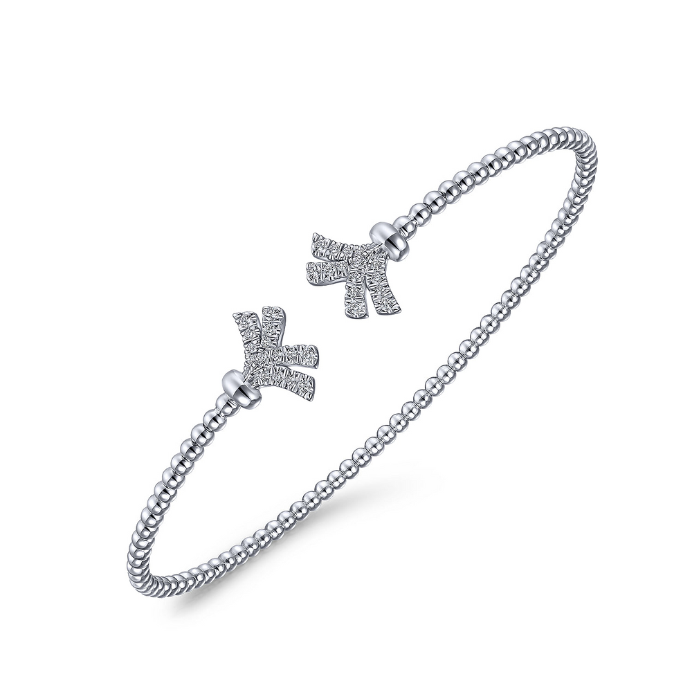 A white-gold bangle bracelet with a beaded band and diamond-set fan motif end caps is angled in the middle of a white background.